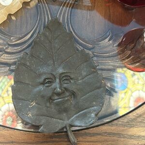 Cast Iron Smiling Leaf Face Sculpture